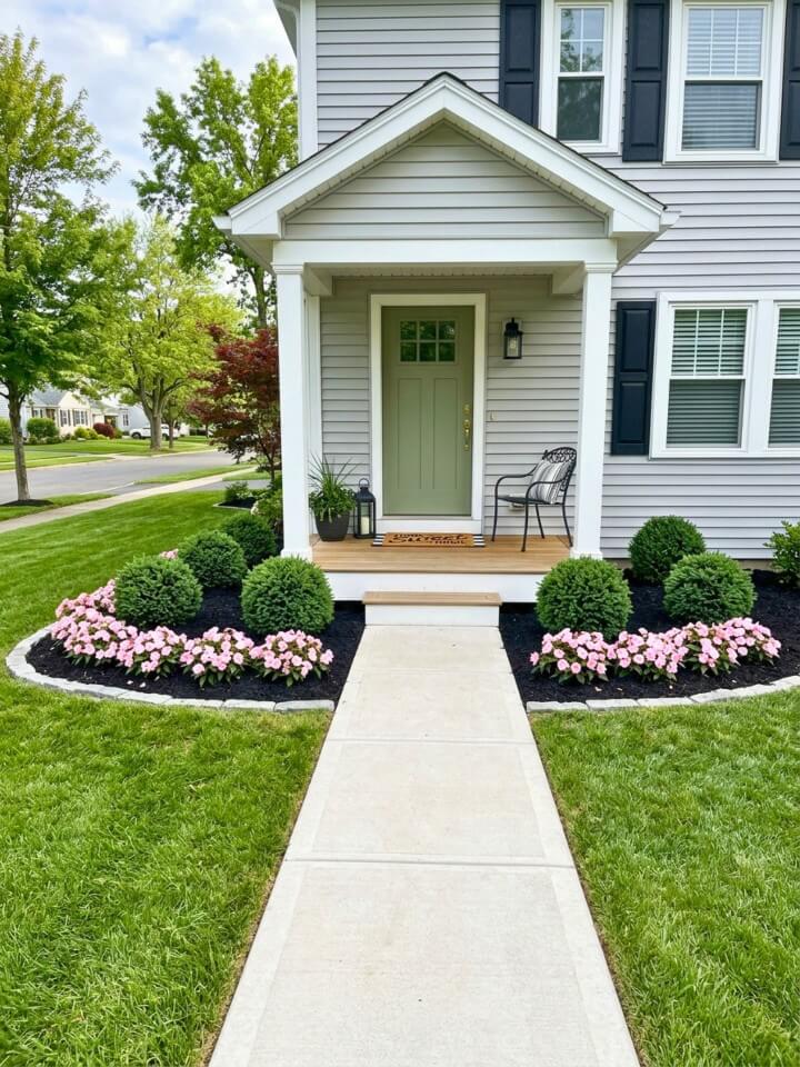 front porch black mulch landscaping with evergreen shrubs