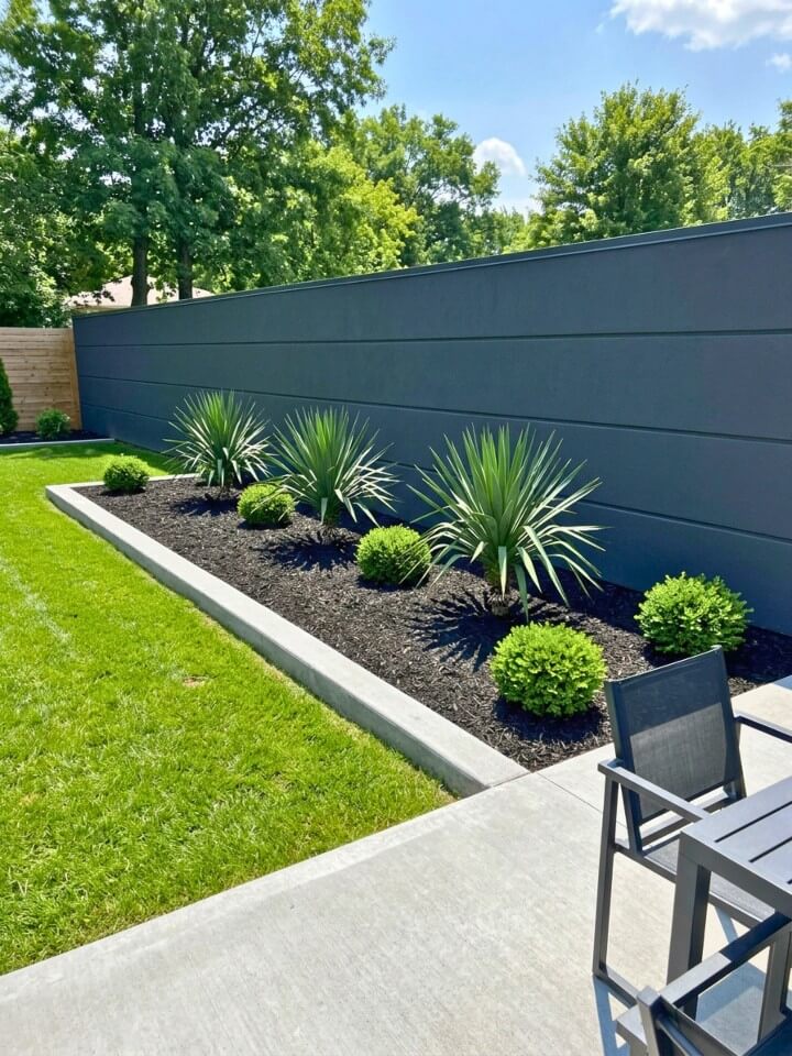 modern black mulch landscaping with concrete edging
