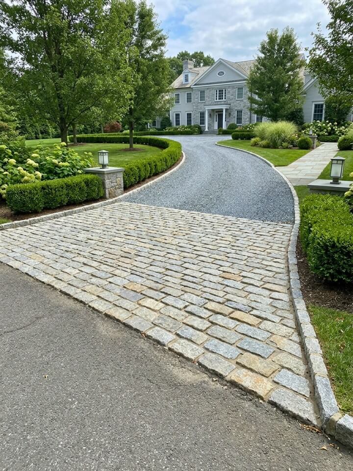 gravel driveway with cobblestone apron